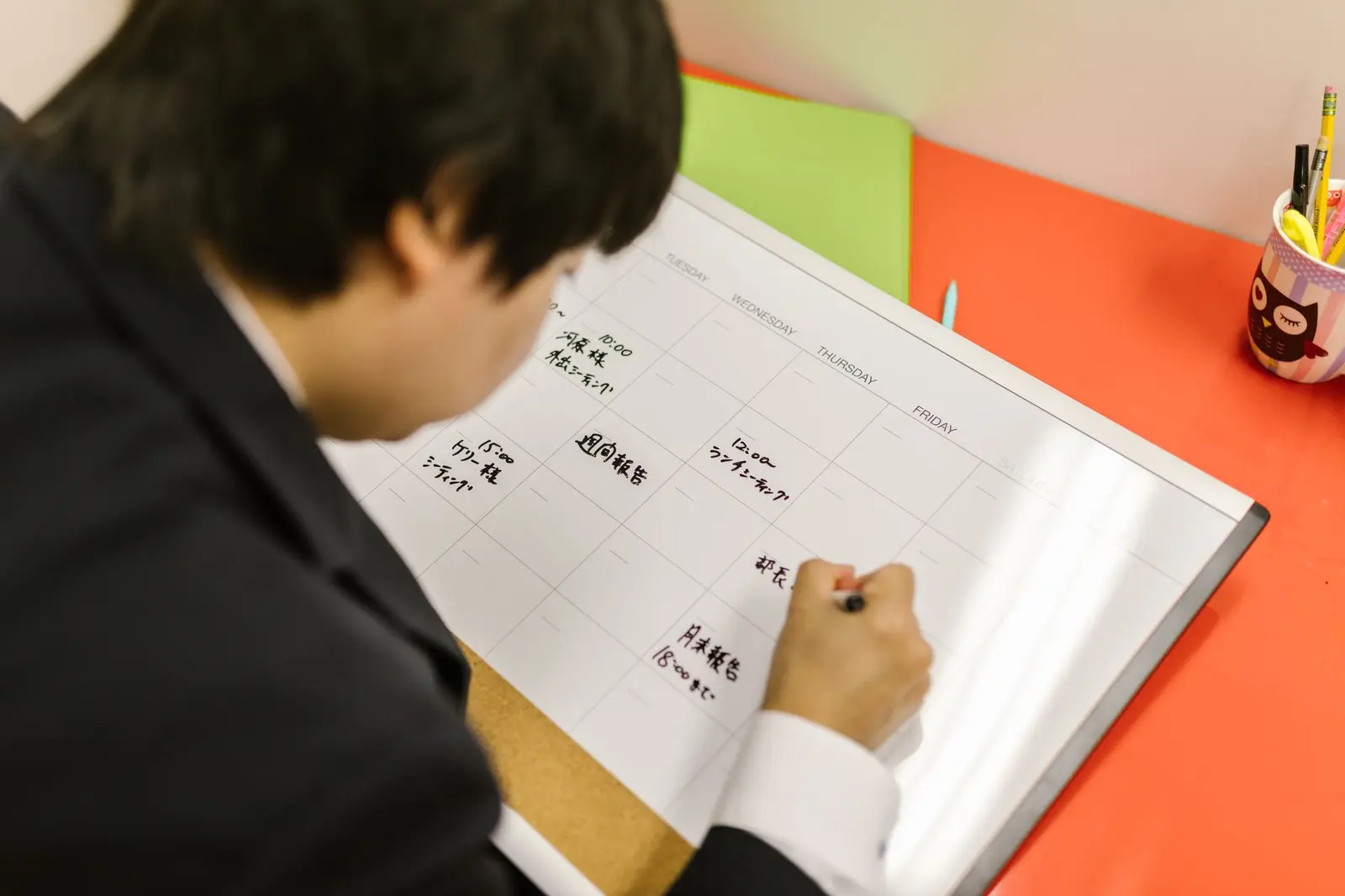 Man mapping out a structured weekly reset plan on a calendar