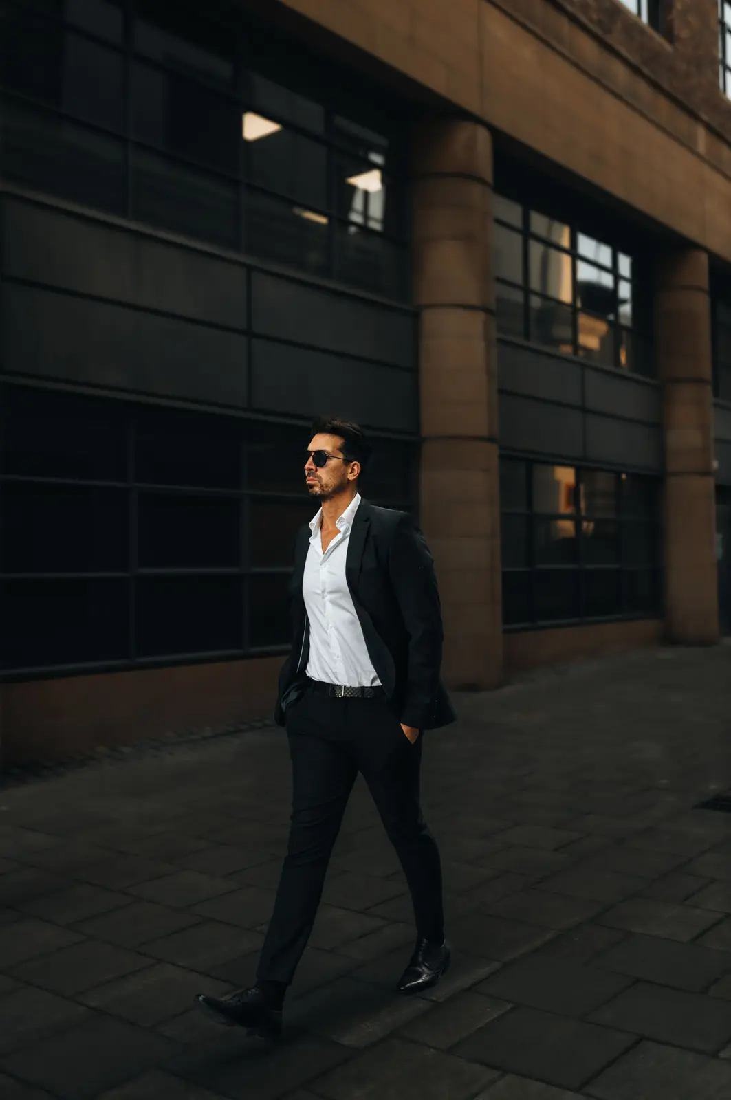 A man walking confidently through the city in work clothes