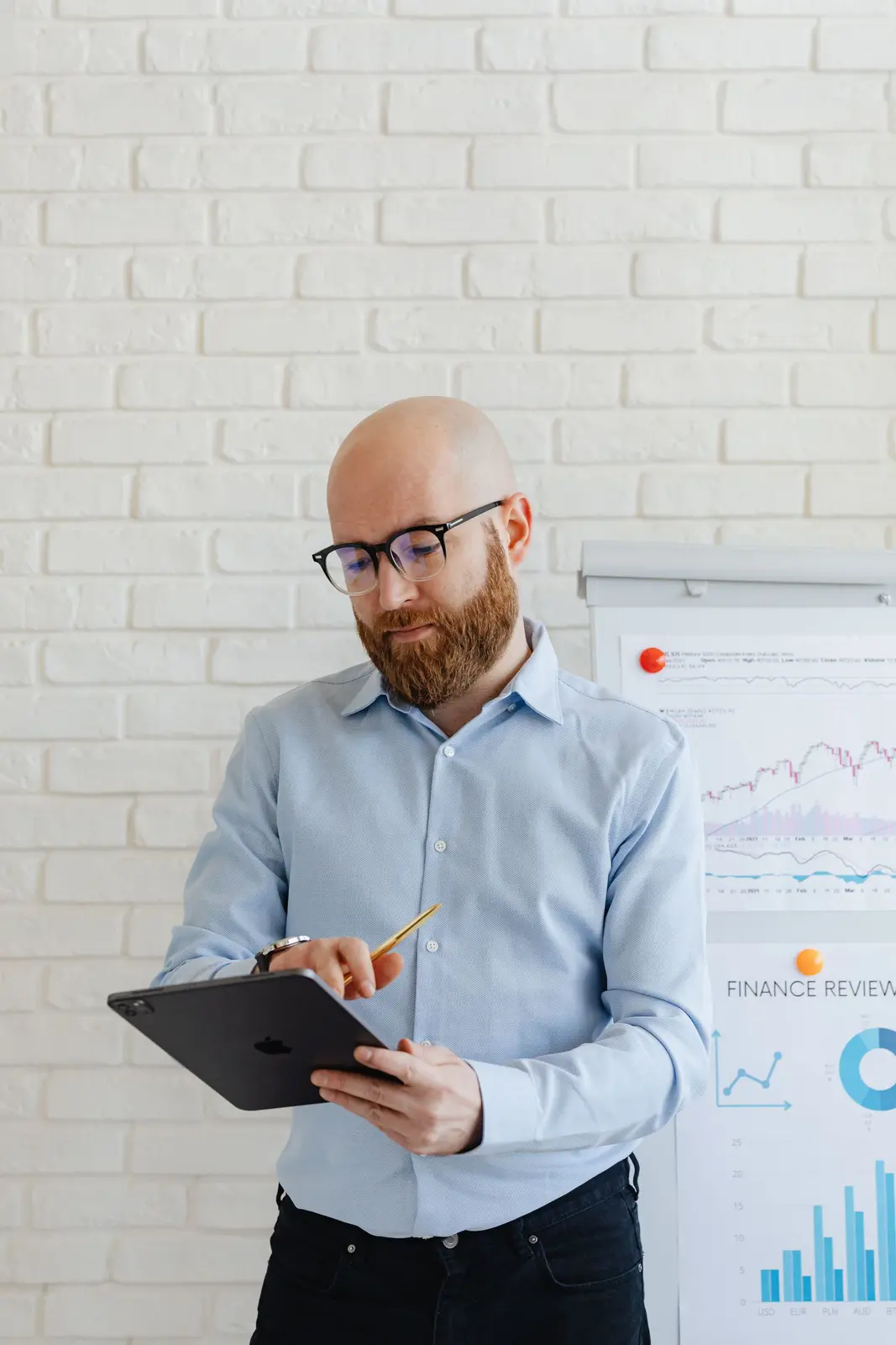 A business owner reviewing his growth numbers on a tablet