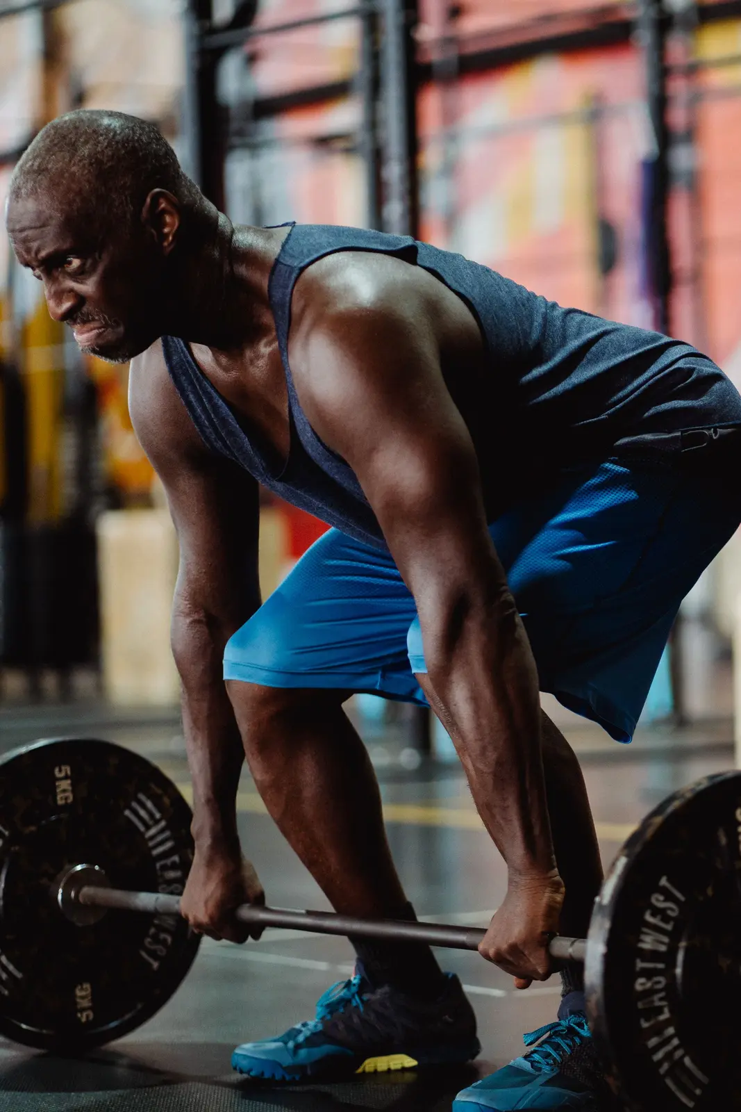 A man deadlifting at the gym, building strength through consistency