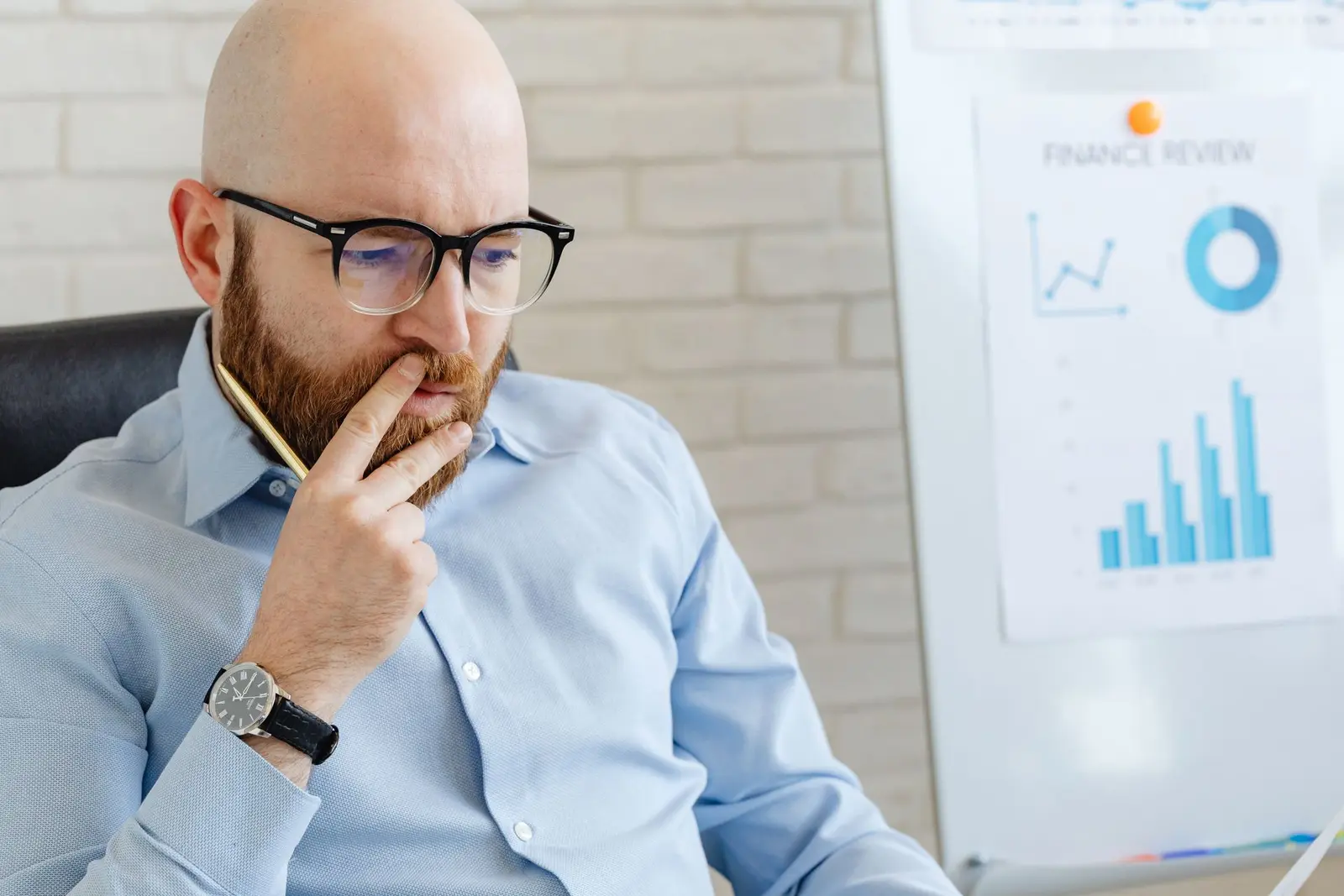 A business owner studying his numbers, thinking through his next move