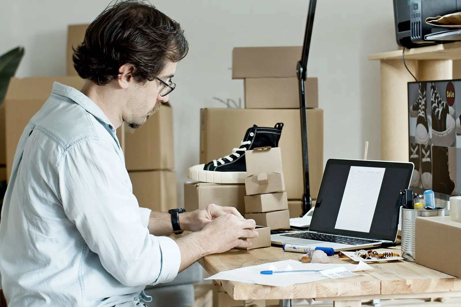 A small business owner packing an online order for a customer