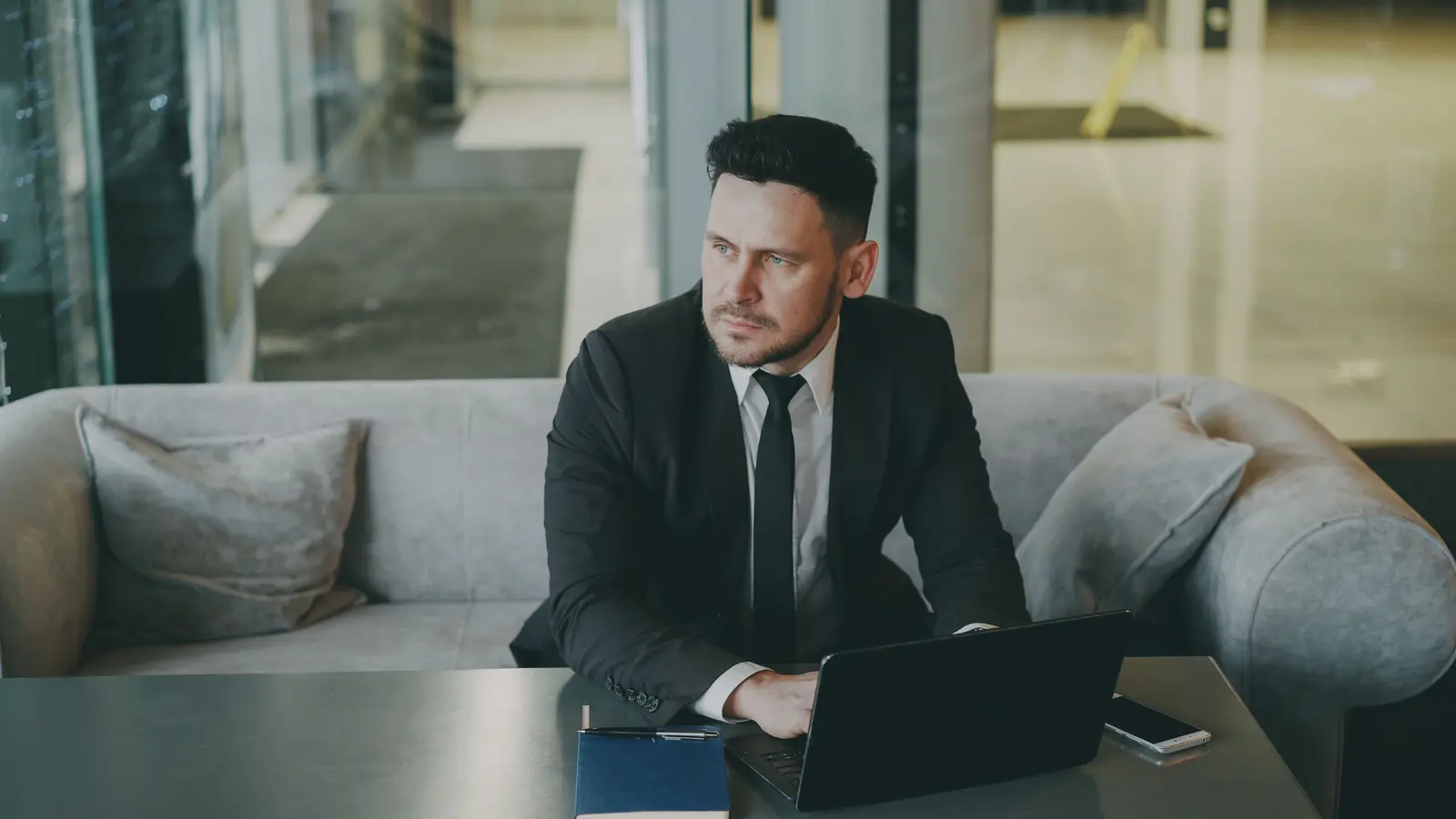 A business owner sitting with his laptop, thinking through his next move