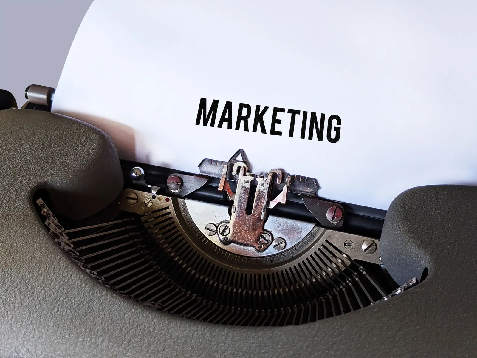 The word MARKETING typed on a vintage typewriter