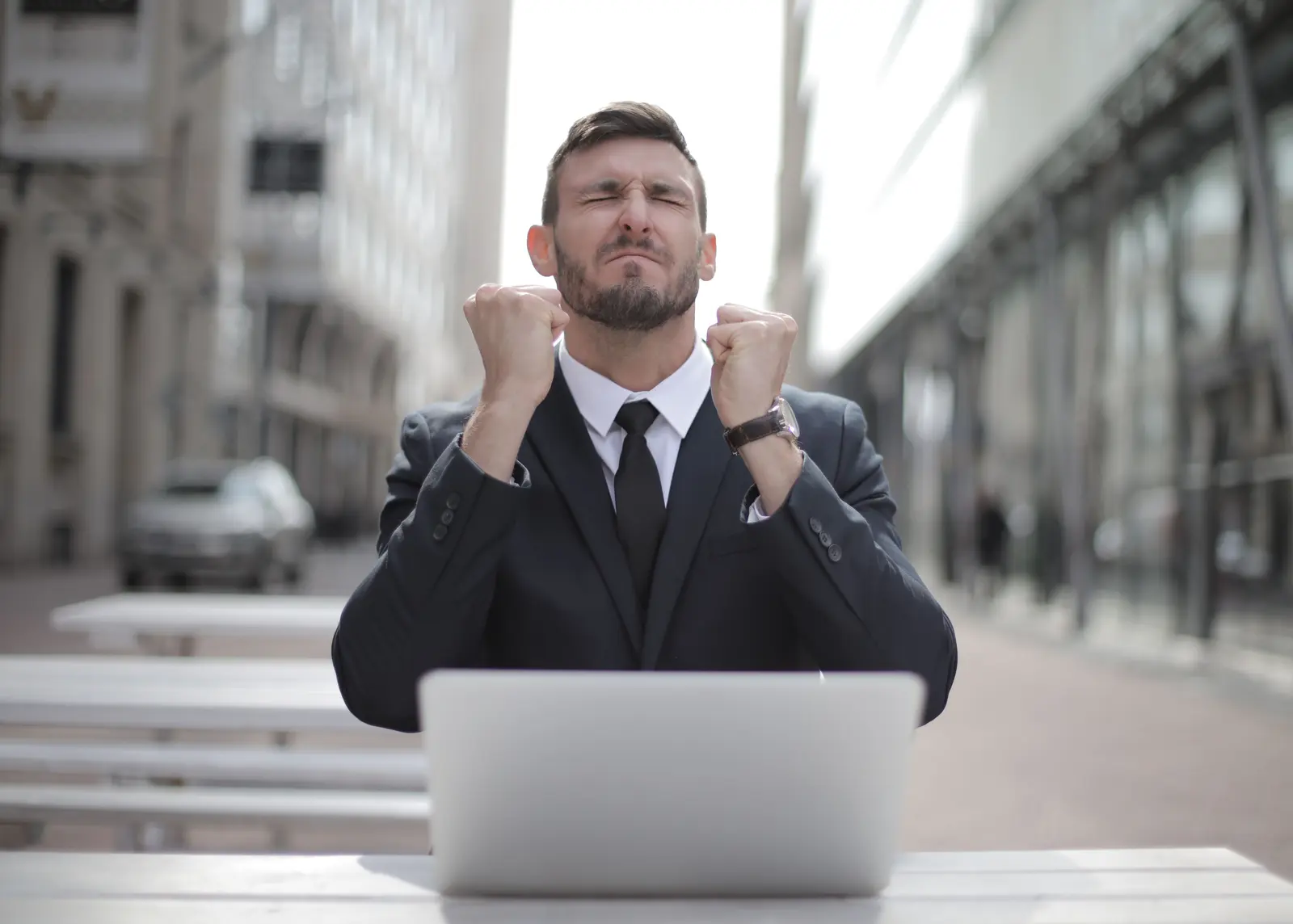 A businessman clenching his fists, determined after a big push