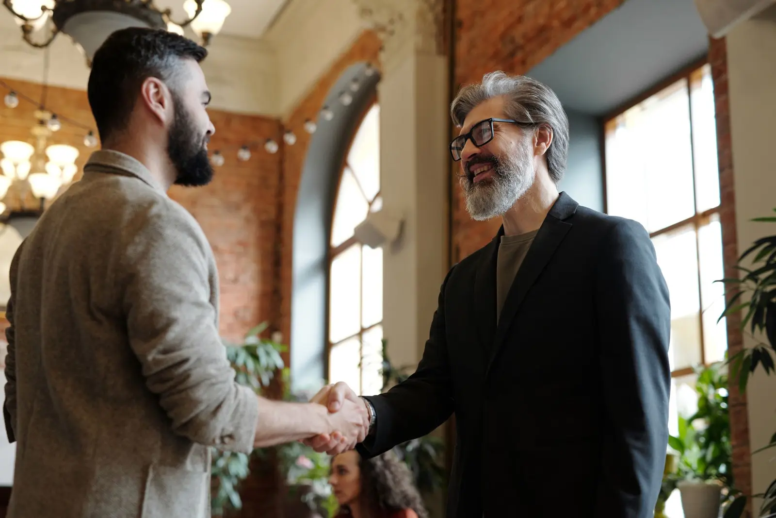 Two business owners shaking hands after closing a deal